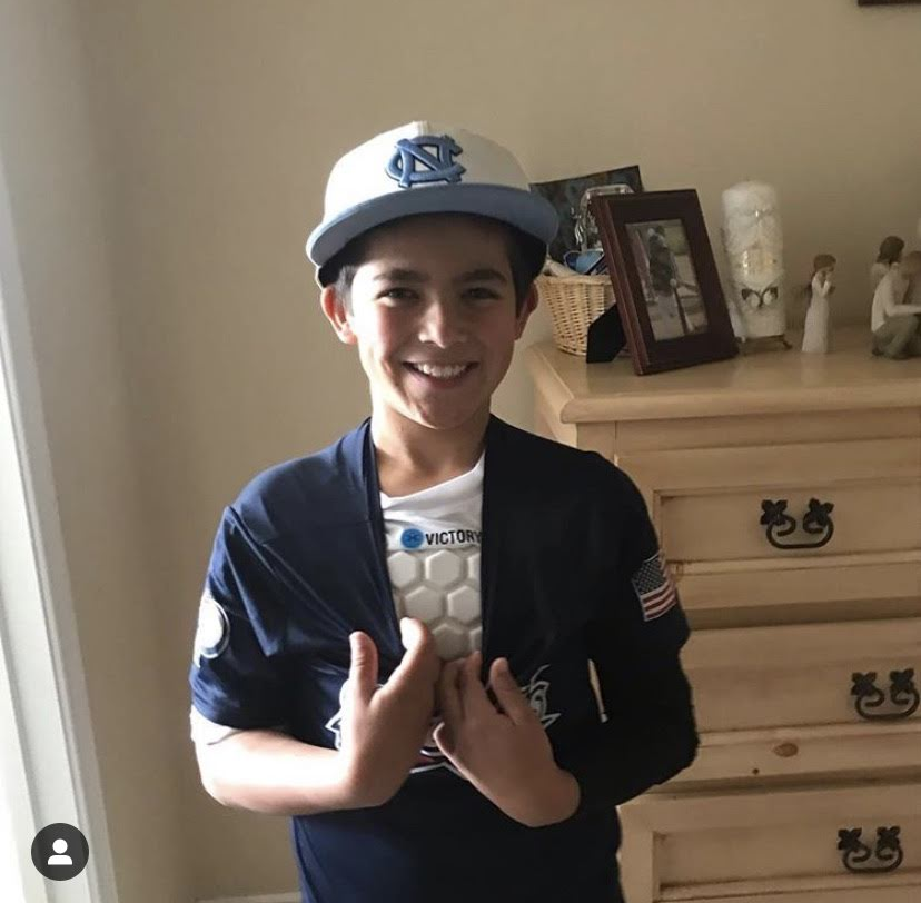 Baseball player with youth baseball and softball protective compression shirt white front view