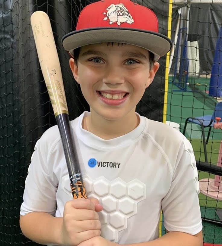 Baseball player with youth baseball and softball protective compression shirt white front view