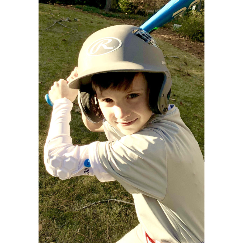 Youth athlete smiling in baseball uniform