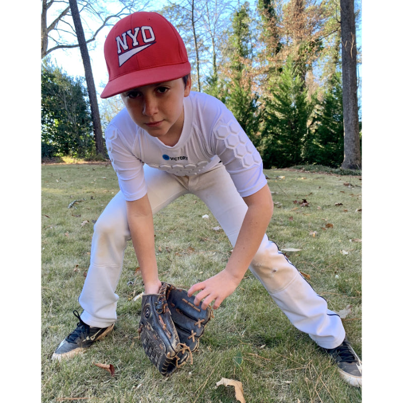 Young baseball player modeling protective appare