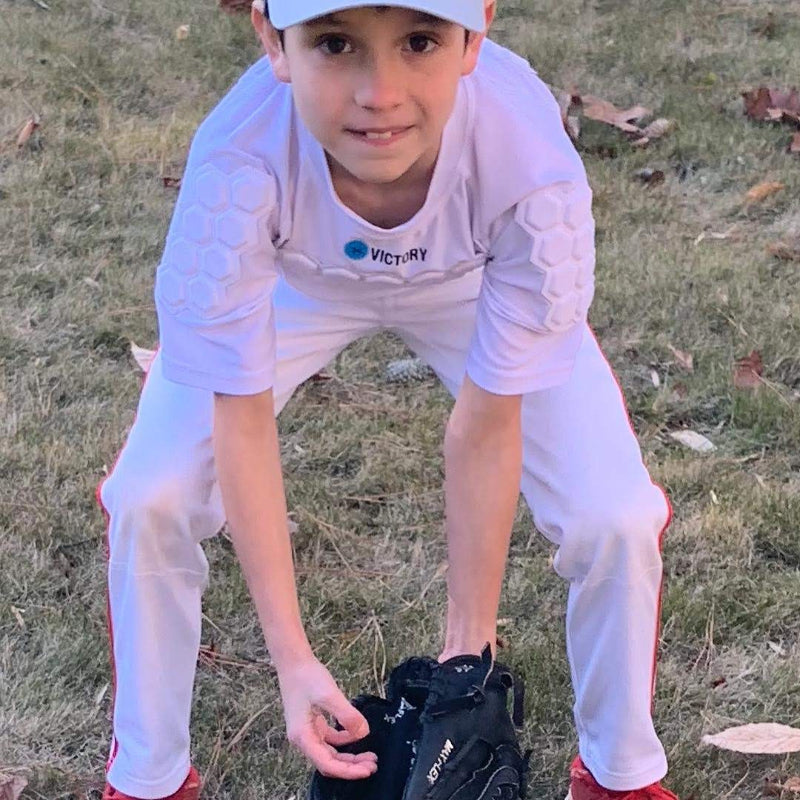 Youth baseball player wearing padded compression shirt