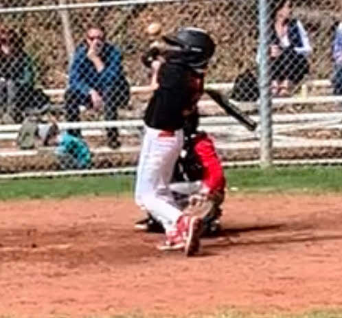 Baseball player being hit by baseball