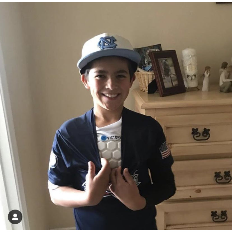 Youth athlete smiling in baseball uniform