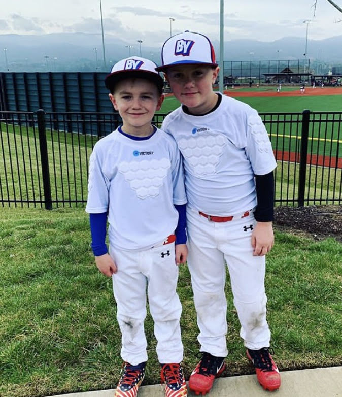 Baseball players with youth baseball and softball protective compression shirt white front view